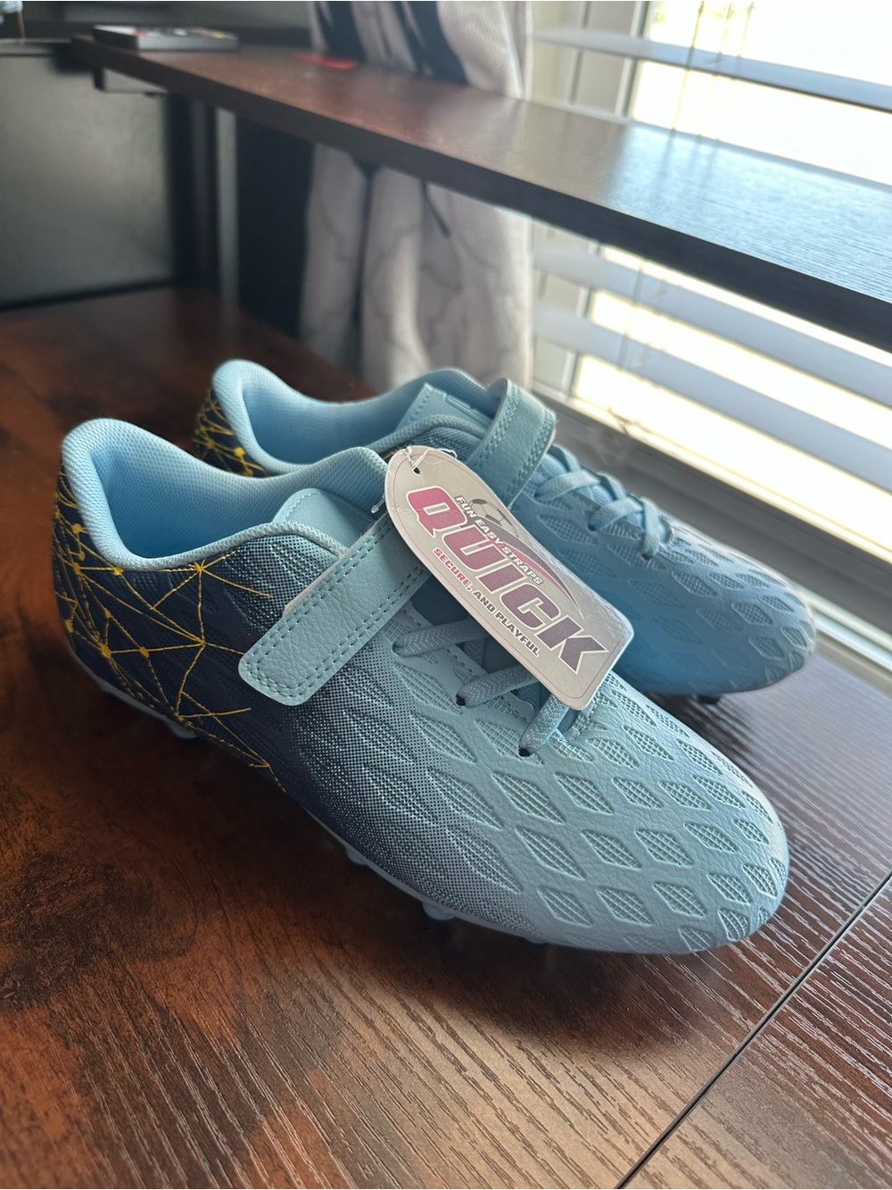 Kids Light Blue Soccer Cleats with Navy & Gold Geometric Heel